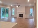 Bright living room featuring a fireplace, built-in cabinets, and sliding glass doors to the outside at 5023 Middleton View Dr., Myrtle Beach, SC 29579