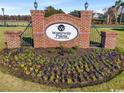 Brick sign for Waterway Palms Plantation surrounded by colorful flowers and manicured landscaping at 5023 Middleton View Dr., Myrtle Beach, SC 29579