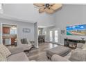 Spacious living area with a ceiling fan, stylish furniture, and seamless flow into the adjacent dining and kitchen spaces at 510 21St Ave. N, North Myrtle Beach, SC 29582