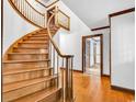 Foyer featuring hardwood floors and a curved wooden staircase at 5704 Woodside Ave., Myrtle Beach, SC 29577