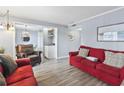 Comfortable living room featuring red couches and wood flooring at 5905 S Kings Highway # 416-A, Myrtle Beach, SC 29575