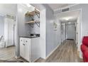 Hallway with wet bar that has a sink, storage and open shelves at 5905 S Kings Highway # 416-A, Myrtle Beach, SC 29575