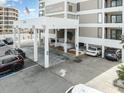 Well-maintained building entrance with covered parking, palm trees and ocean views at 6200 N Ocean Blvd. # 501, North Myrtle Beach, SC 29582
