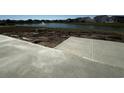 Sidewalks being added to the home construction site, view of the surrounding homes and pond at 899 Agostino Dr., Myrtle Beach, SC 29579