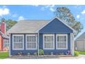 Attractive blue home showcasing well-maintained landscaping and a charming curb appeal at 1006 Charles St., North Myrtle Beach, SC 29582