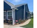 Beautiful blue home highlighting manicured landscaping and a sidewalk at 1006 Charles St., North Myrtle Beach, SC 29582