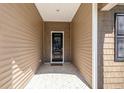 A welcoming covered porch with brick flooring leads to the front door at 10141 Hamilton Branch Loop, Myrtle Beach, SC 29579