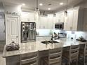 Modern kitchen features white cabinetry, granite countertops, stainless steel appliances, and a breakfast bar at 1024 Ray Costin Way # Villa 711, Murrells Inlet, SC 29576