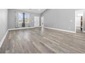 Bright living room with wood floors, neutral paint, and access to the kitchen at 108 Silver Peak Dr., Conway, SC 29526