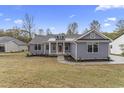 Charming house with light blue siding, inviting front porch, and professionally landscaped yard at 1110 N Middleton Dr. Nw, Calabash, NC 28467