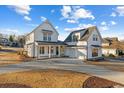 Stunning modern farmhouse featuring a white exterior, dark trim, and a spacious driveway at 115 S Middleton Dr. Nw, Calabash, NC 28467