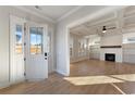 Bright living room with hardwood floors, a fireplace, built-ins, and a coffered ceiling at 115 S Middleton Dr. Nw, Calabash, NC 28467