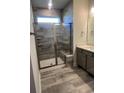 Bathroom featuring a tiled shower with glass door, a bench, and modern fixtures at 1241 Lady Bird Way, North Myrtle Beach, SC 29582