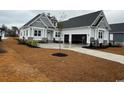 Spacious two-story home with an attached garage, well-maintained landscaping, and a cozy curb appeal at 135 Low Country Loop, Murrells Inlet, SC 29576