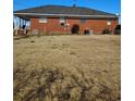 Brick house with a large, grassy backyard and minimal landscaping at 1375 Kenny Jordan Rd, Tabor City, NC 28463