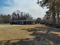 Ranch-style house with a long, covered porch and expansive front yard at 1375 Kenny Jordan Rd, Tabor City, NC 28463