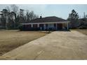 Single-story brick home with attached carport and long cracked driveway at 1375 Kenny Jordan Rd, Tabor City, NC 28463