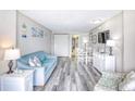 Cozy living room featuring a blue sofa, dining table, and nautical-themed decor at 1501 S Ocean Blvd. # 844, Myrtle Beach, SC 29577