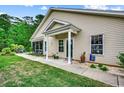 Inviting home entrance featuring a covered porch and a meticulously maintained lawn at 196 Rose Water Loop, Myrtle Beach, SC 29588