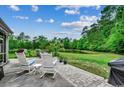 Relaxing outdoor patio with rocking chairs and a picturesque view of the serene pond at 196 Rose Water Loop, Myrtle Beach, SC 29588