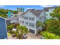 Inviting exterior with light blue siding, a two-story porch, and palm trees for that relaxed, coastal feel at 209B Woodland Dr., Murrells Inlet, SC 29576