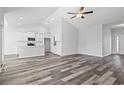 Open-concept space showcases wood-look flooring, recessed lighting, and a vaulted ceiling with a ceiling fan at 272 Stillbrook Dr., Longs, SC 29568
