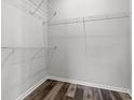 A simple walk-in closet features wire shelving and wood-look floors to maximize organization and style at 272 Stillbrook Dr., Longs, SC 29568