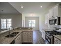 Modern kitchen featuring granite countertops, stainless steel appliances, and white cabinetry at 275 Stillbrook Dr., Longs, SC 29568
