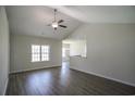 Bright living room with ceiling fan, wood floors, and large window providing natural light at 275 Stillbrook Dr., Longs, SC 29568