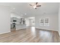 Open concept living space featuring the kitchen, dining and living rooms and wood-look flooring at 276 Stillbrook Dr., Longs, SC 29568