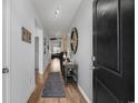 Inviting hallway features stylish decor and leads into a spacious living area with lots of natural light at 2882 Ophelia Way, Myrtle Beach, SC 29577