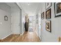 Bright hallway leads to various rooms, adorned with stylish decor, including framed portraits at 2882 Ophelia Way, Myrtle Beach, SC 29577