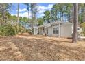 Inviting single-story home with manicured landscaping and mature trees at 3026 Cedar Creek Run, Little River, SC 29566