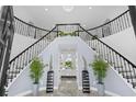 Elegant foyer featuring a grand staircase, marble floors, and sophisticated decor at 3700 Waterford Dr., Myrtle Beach, SC 29577