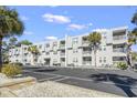 Multi-story condo building with multiple balconies, ample parking, and manicured landscaping at 401 Hillside Dr. N # 2F, North Myrtle Beach, SC 29582
