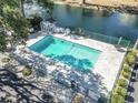 Refreshing community pool surrounded by lush greenery and a secure fence at 401 Hillside Dr. N # 2F, North Myrtle Beach, SC 29582