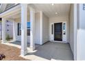Inviting front porch with stylish columns and a sleek black front door at 4028 Bucolic Loop, Myrtle Beach, SC 29588