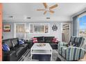 Cozy living room with nautical decor, comfortable seating, and bright natural light from large windows at 409 25Th Ave. N, North Myrtle Beach, SC 29582