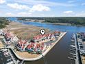 Breathtaking aerial view of the townhome complex nestled between a beautiful river and a scenic marina, offering picturesque waterfront living at 4396 Baldwin Ave. # 138, Little River, SC 29566