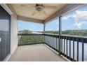Condo balcony with ceiling fan and expansive views of the intercostal waterway and trees at 4445 Kingsport Rd. # 406, Little River, SC 29566
