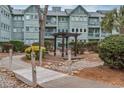 Scenic exterior view highlighting a walkway leading to a gazebo amid lush landscaping, offering a tranquil retreat at 5905 South Kings Hwy. # 4219-D, Myrtle Beach, SC 29575