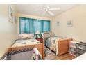 Cozy bedroom with two beds, a ceiling fan, and bright beach-themed decor for a relaxing ambiance at 5905 South Kings Hwy. # 4107-D, Myrtle Beach, SC 29575