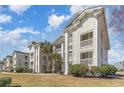 Attractive condo complex showcasing multiple stories, private balconies, and well-manicured green spaces at 597 Blue River Ct. # H2, Myrtle Beach, SC 29579