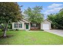 Inviting single story home with a well manicured lawn, attached garage and mature shade tree at 6006 Quinn Rd., Myrtle Beach, SC 29579