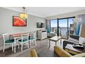 Inviting living area with a comfortable sofa, dining set, and balcony access offering scenic views at 7200 N Ocean Blvd. # 662, Myrtle Beach, SC 29572