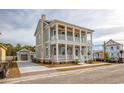 Two-story home with double balconies, ceiling fans, detached garage, and well-manicured landscaping at 8053 Laurel Ash Ave., Myrtle Beach, SC 29572