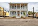 Charming two-story home features double balconies, a covered front porch, and classic architectural details at 8053 Laurel Ash Ave., Myrtle Beach, SC 29572