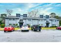 Exterior of the townhome featuring ample parking with a red and black truck at 10301 N Kings Hwy. # 15-8, Myrtle Beach, SC 29572