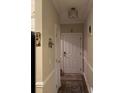 View of the home's neutral entryway with coat rack, decor, and area rug at 1101 Louise Costin Ln. # 1308, Murrells Inlet, SC 29576