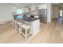 Modern kitchen featuring a large island with seating and stainless steel appliances at 1211-B N Waccamaw Dr., Garden City Beach, SC 29576